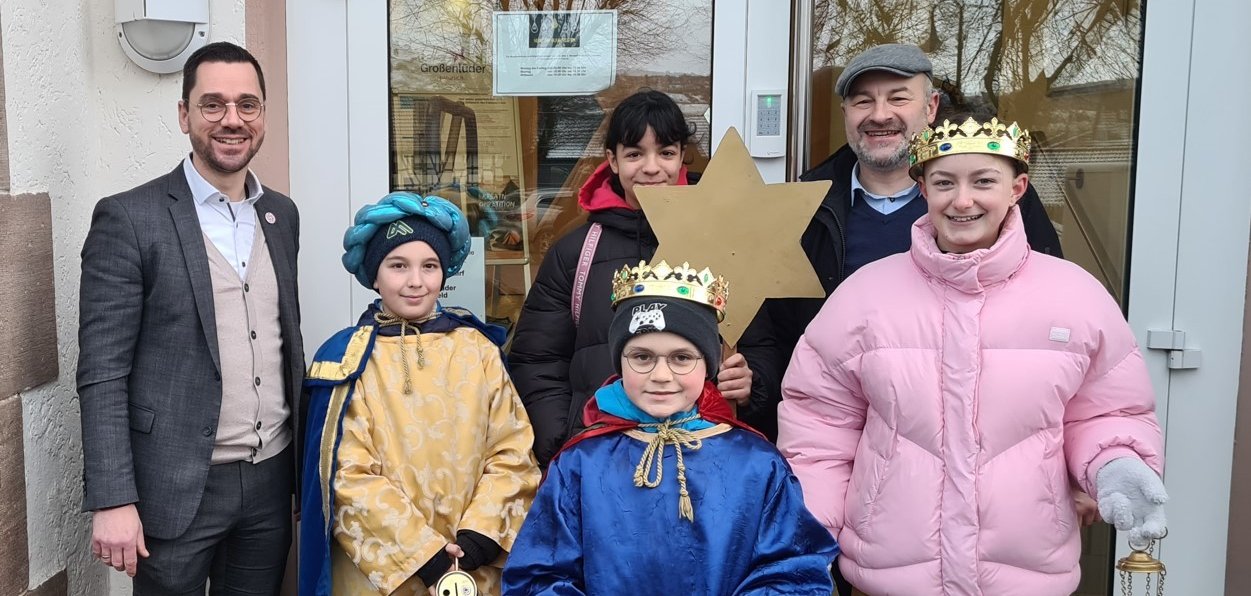 Sternsinger mit Diakon Wojciech Gofryk und Bürgermeister Florian Fritzsch vor dem Eingang des Rathauses