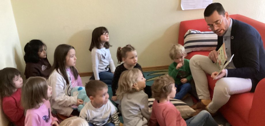 Bürgermeister Florian Fritzsch liest den Kindern der Kita Farbenspiel beim bundesweiten Vorlesetag vor. 